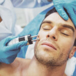 Man receiving a professional facial treatment at a skincare clinic.